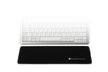 black trapezium compact wrist support positioned in front of a compact keyboard