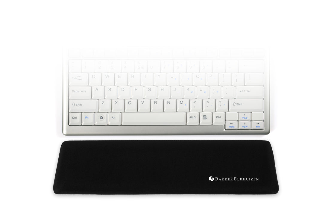 black trapezium compact wrist support positioned in front of a compact keyboard