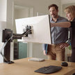 image showing two colleague collaborating whilst using the ergotron trace monitor arm