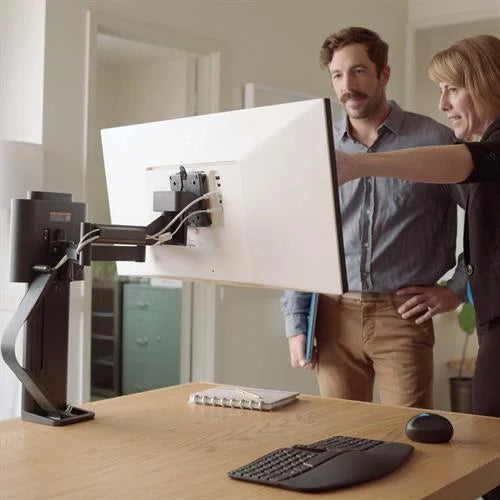 image showing two colleague collaborating whilst using the ergotron trace monitor arm