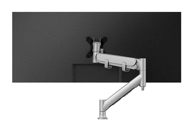 A silver monitor arm mounted on a flat surface with cable management visible.