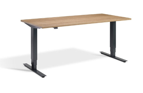 Wooden desk with black adjustable legs on a white background