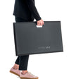 person carrying anti fatigue mat using in-built handle