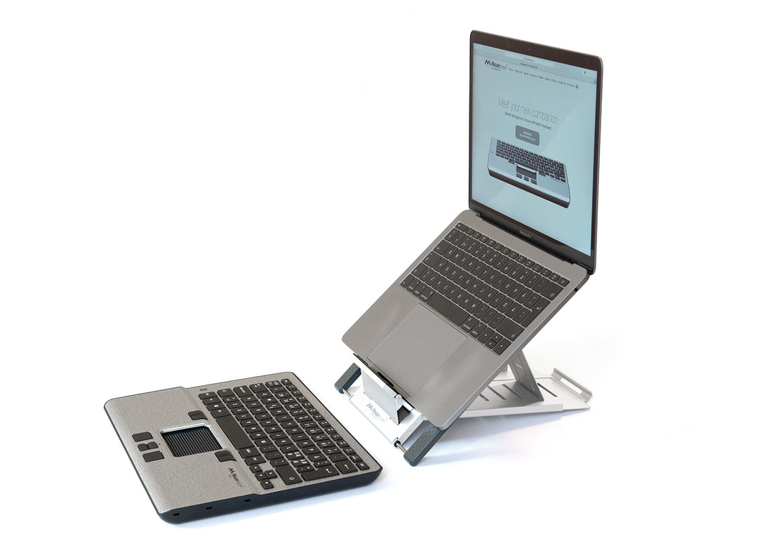 laptop on laptop riser with keyboard and mouse in front