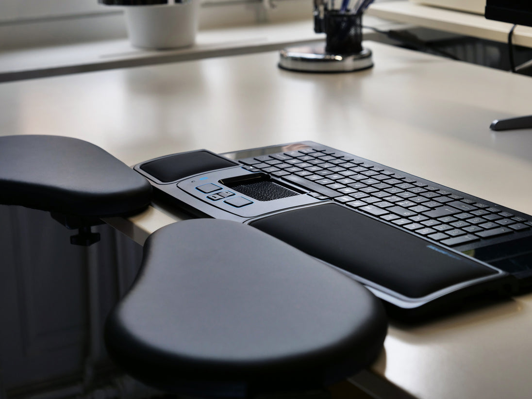 two individual forearm supports clamped on desk