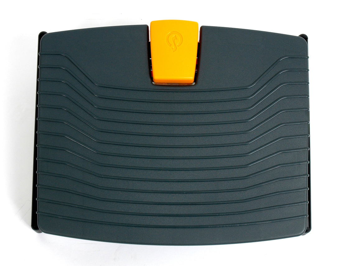 black footrest with orange button for height adjustment