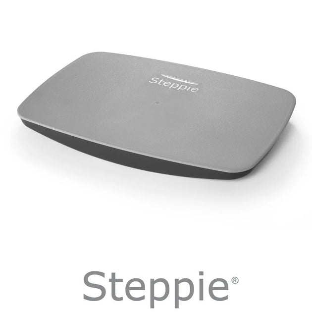A gray Steppie balance board with the brand logo visible on the surface.